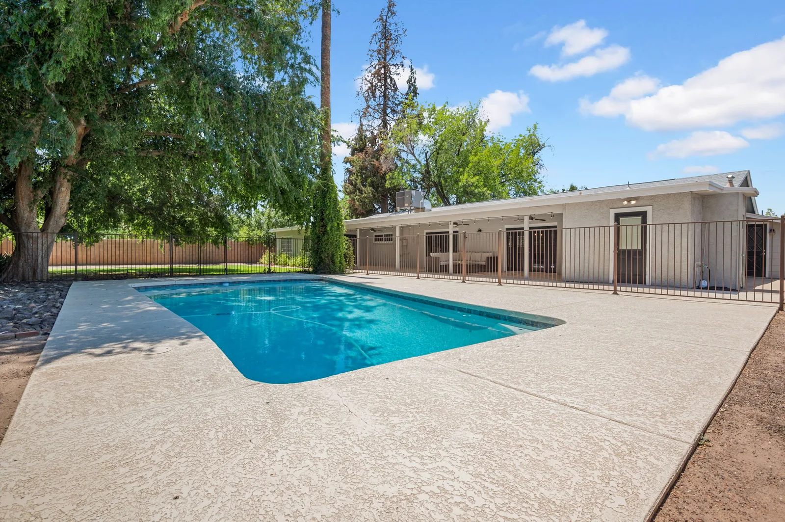 Pool and deck looking back at the low ranch roofline.