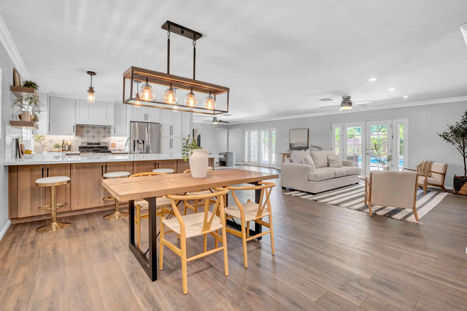 Kitchen island with waterfall quartz opening to the great room and back yard doors.