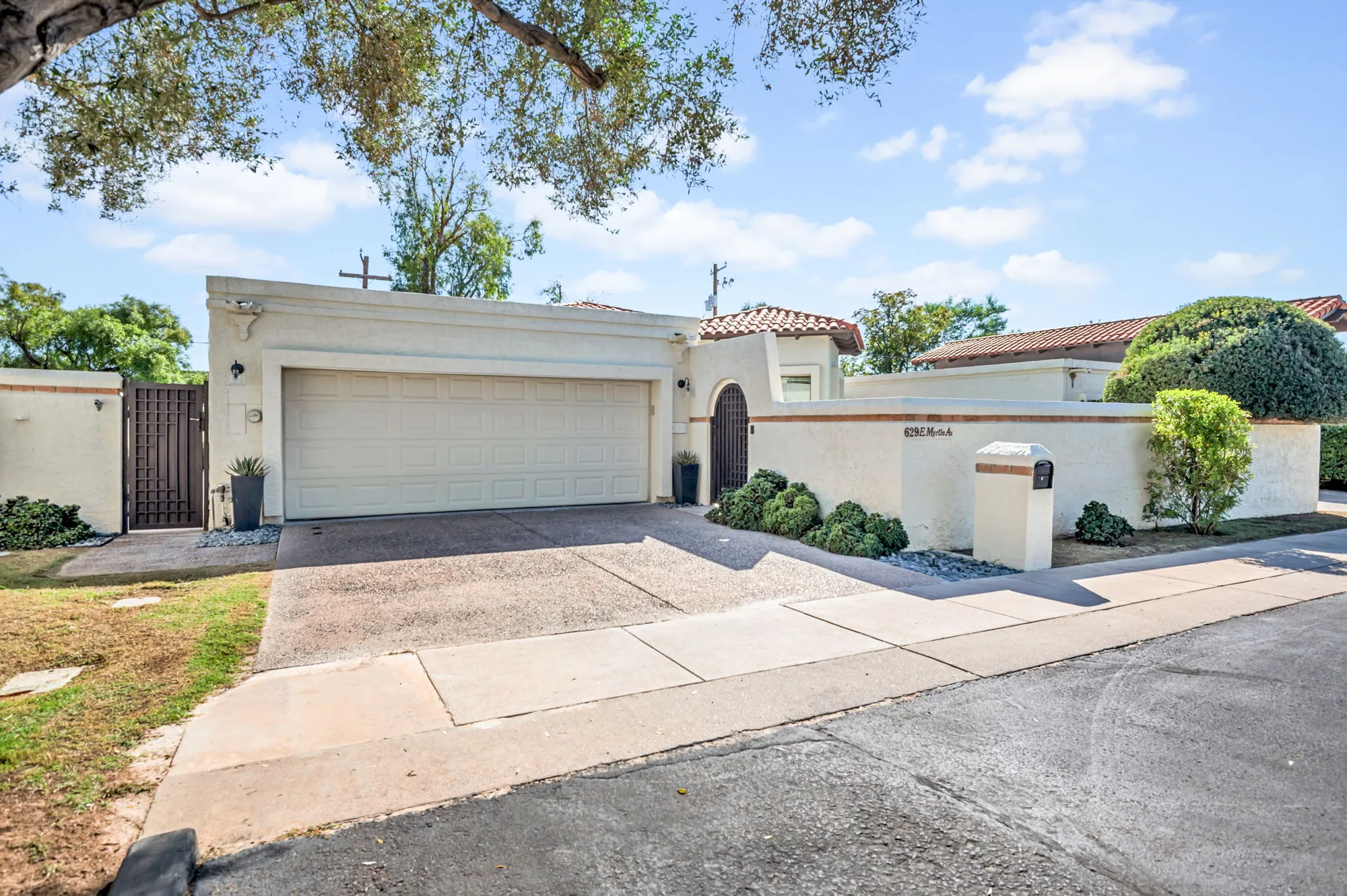 Front of the classic North Central ranch at 629 E Myrtle Ave, white stucco with a red tile roof.
